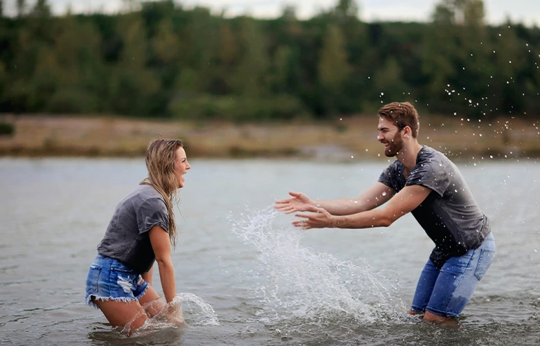A Leo man and Gemini woman having fun playing on body of water