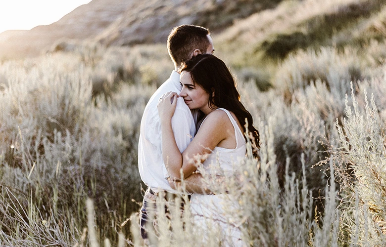 A couple looking happy while hugging each other