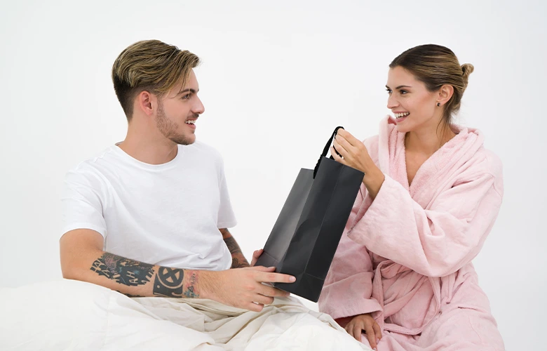 A girl looking happy while receiving a gift from her boyfriend