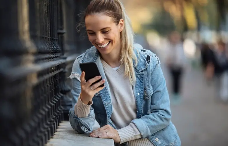 A girl laughing at a text message