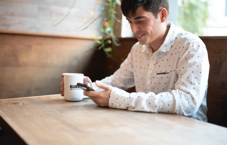 A happy man texting a girl