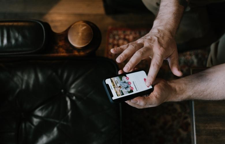 A man visits his Tinder match's profile.