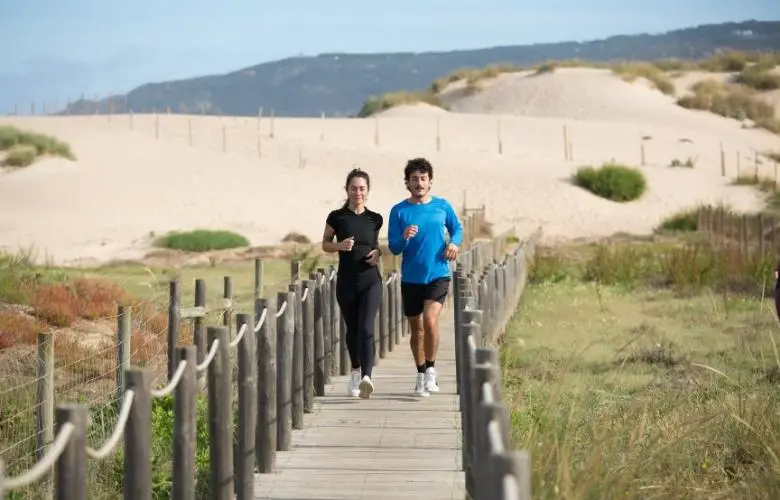 Man and Woman Jogging on a Boardwalk