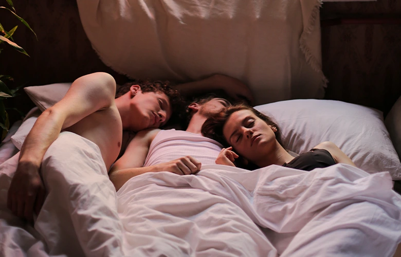 Three people sleeping on bed after exploring their MFM sexuality