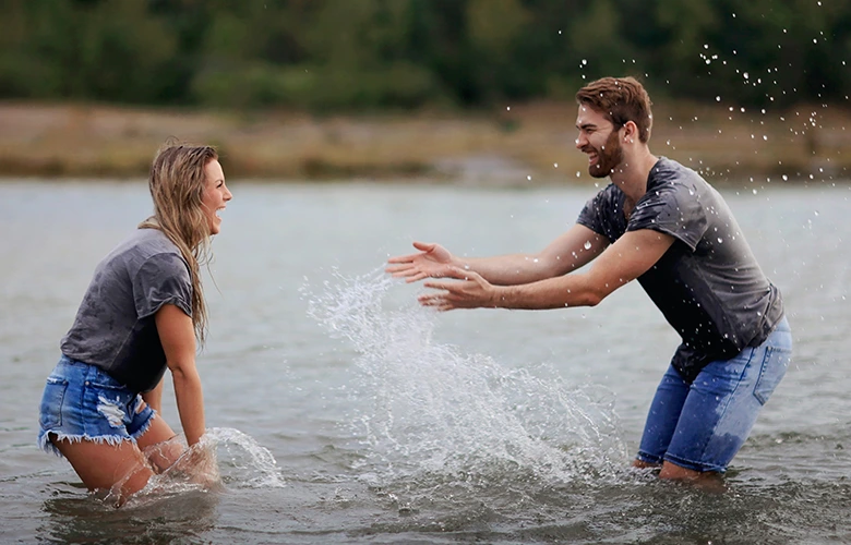 A Capricorn man enjoys playing with his girlfriend on a lake