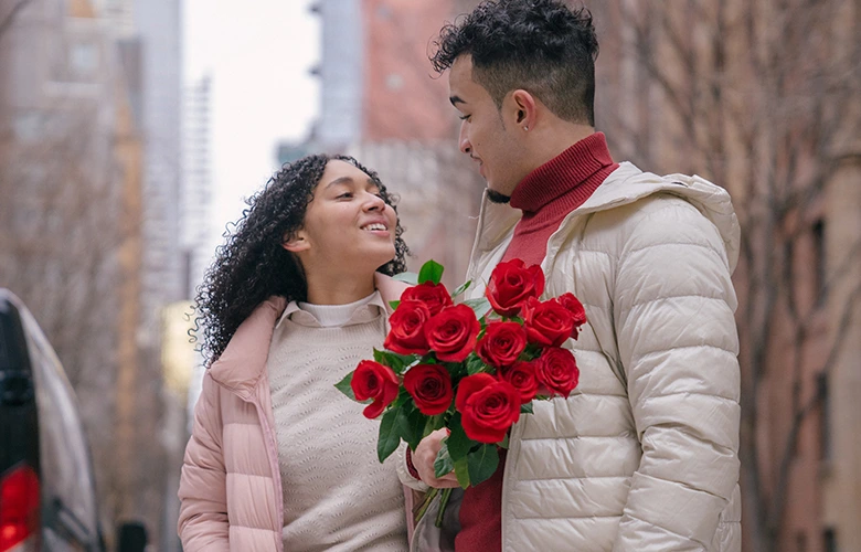 A guy giving his girlfriend roses on their date